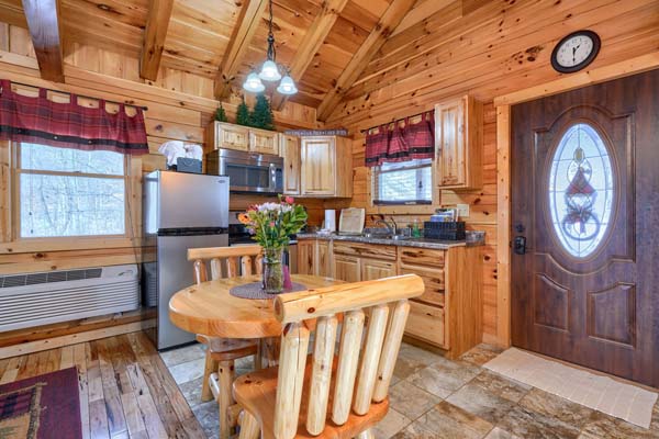 Kitchen with dining table and appliances beside the front door