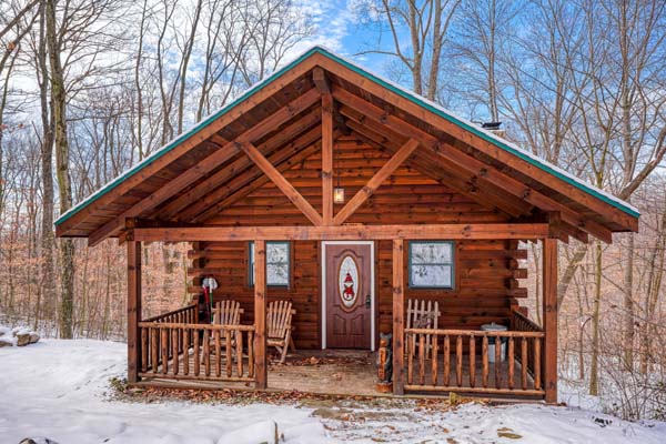 Front view of the log cabin and covered porch