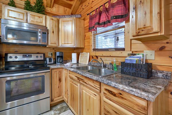 Kitchen sink below the window with range and microwave