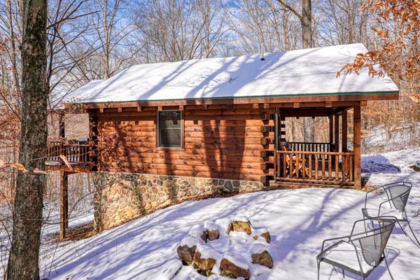 Side view of the cabin showing the porch and elevated rear deck