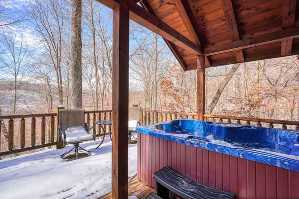 Back deck with hot tub and patio furniture