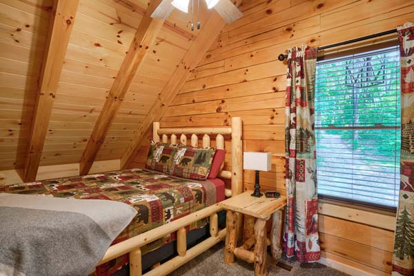 Loft bedroom with queen log bed