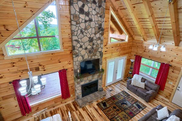 Living room with natural light and stone fireplace