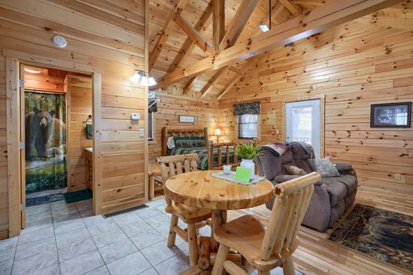 Dining area with wooden table and sofa behind