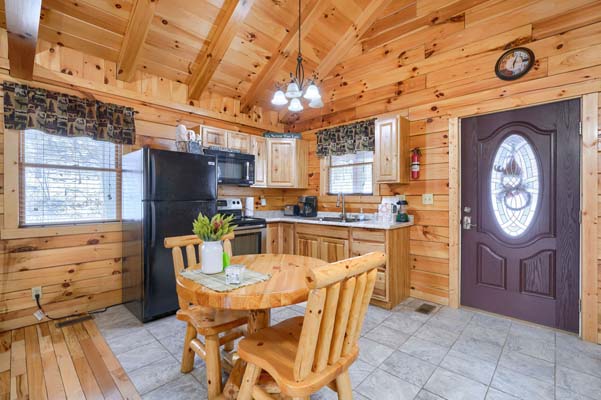 Dining table with the kitchen and entry door behind