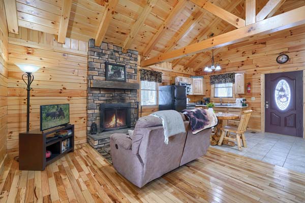 Living area with sofa facing the stone fireplace
