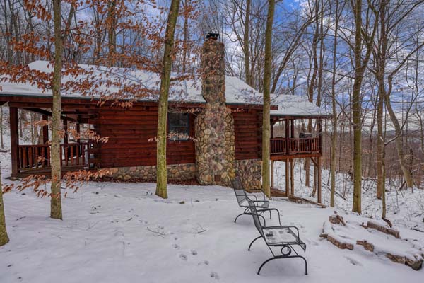 Side view of the cabin and its stone chimney