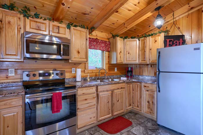 Kitchen with range and refrigerator