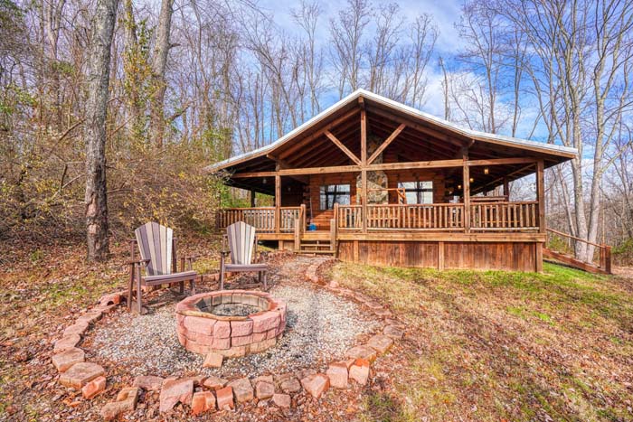 Cabin and gravel drive in the woods