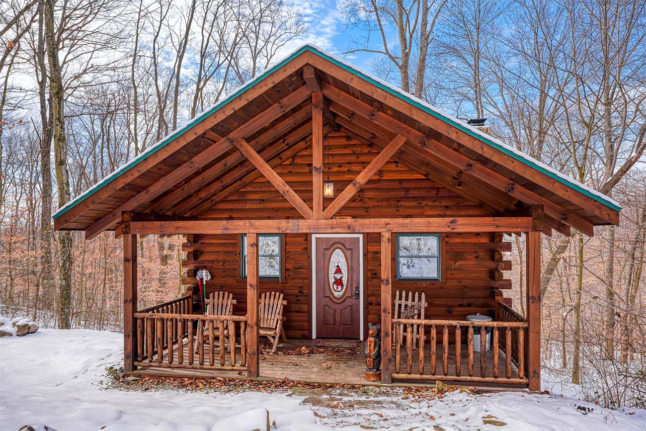 Bear Hugs Cabin at dusk with a lit fire ring