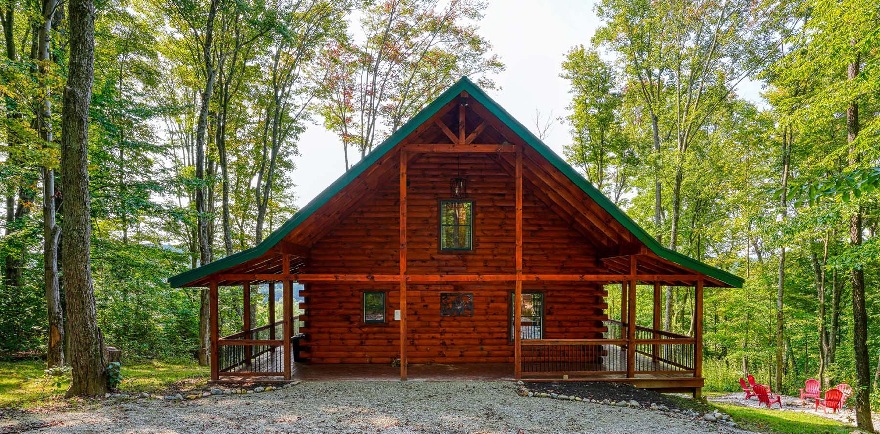 Big Bear Retreat, a large log home with wrap around covered porches in the woods