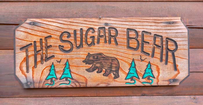 The Sugar Bear carved wooden cabin sign